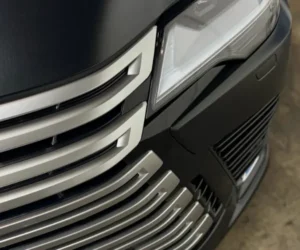 A side profile view of the black sports car under professional studio lighting.