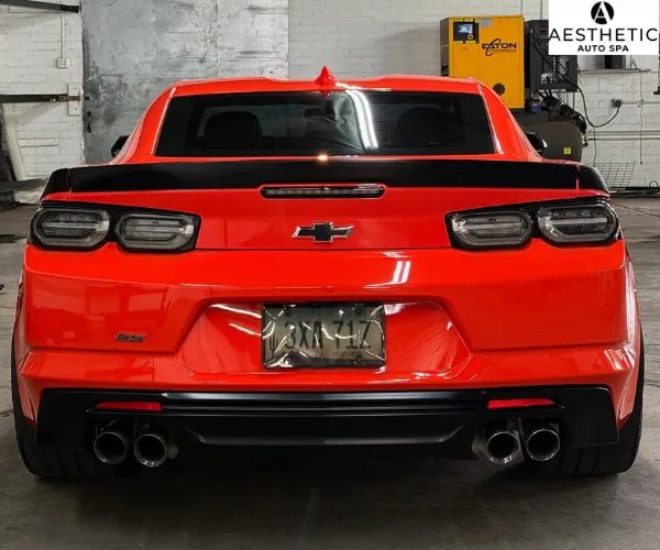 high-gloss finish under garage lighting, referencing paint correction